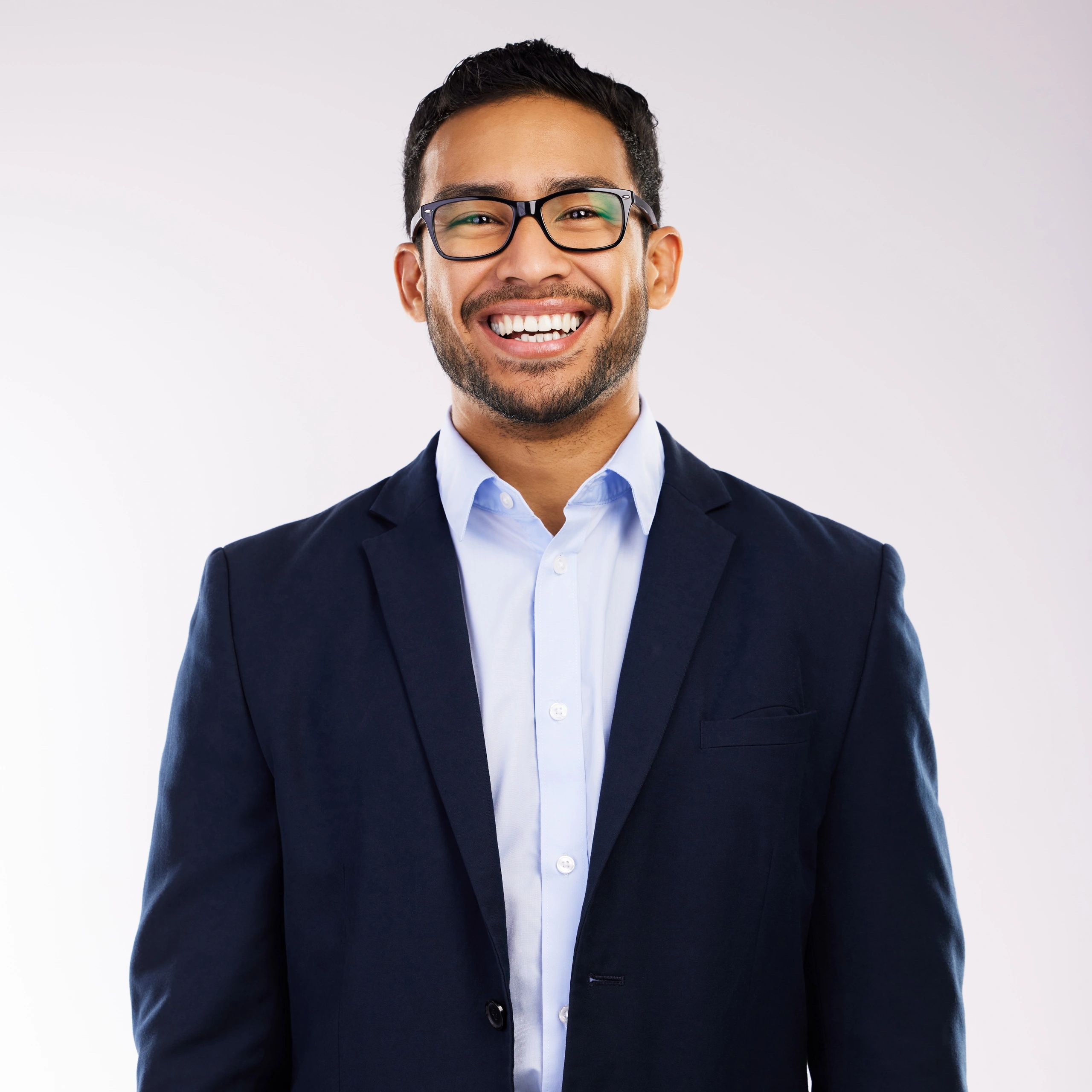 Professional headshot of a man against a neutral background