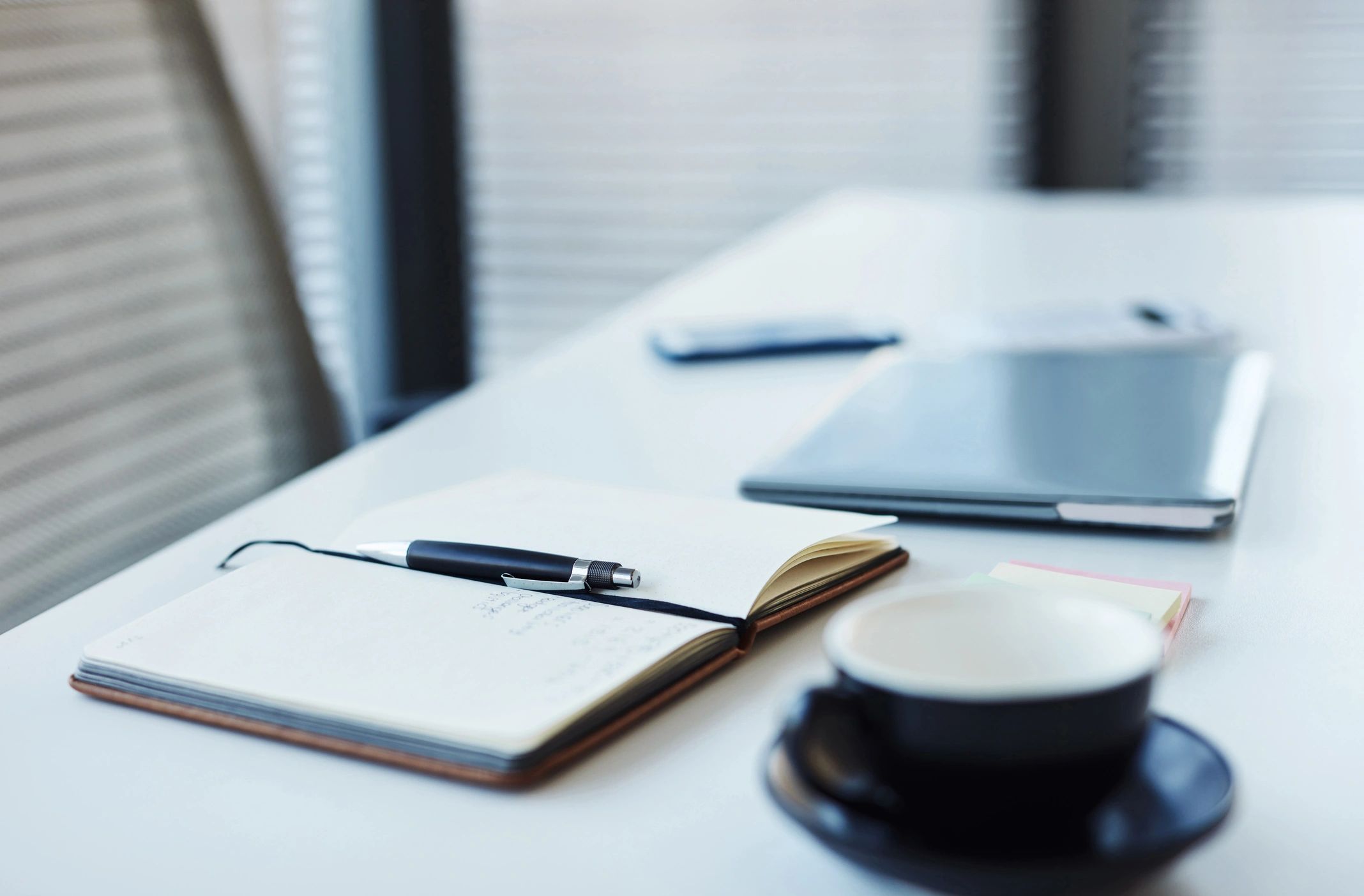 Notebook and laptop on a desk for planning and strategy