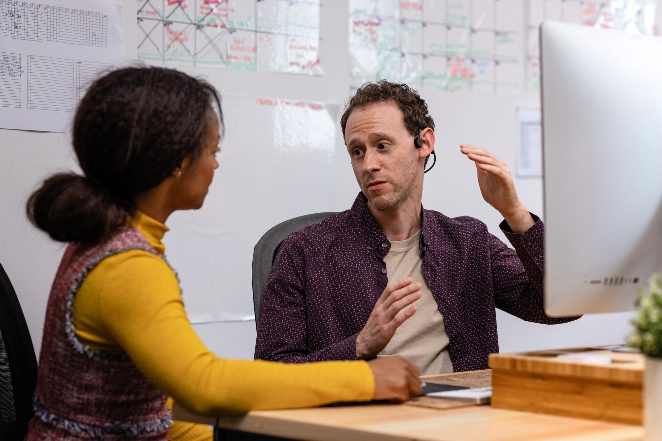 Consultant collaborating with a colleague at a computer